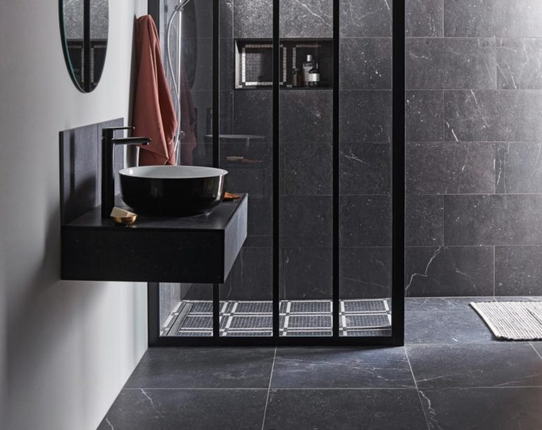 Carrelage effet marbre noir dans une salle de bain avec douche à l'italienne